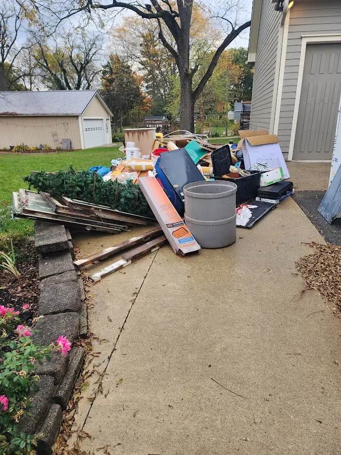 Dumpster being loaded with debris for Estate Cleanout Dumpster Rental in Silsbee